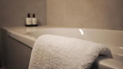 a white bath tub with a white towel on it at City and Sea 12 in Larnaka