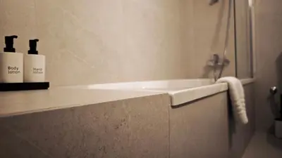 a bathroom with a bath tub with a towel at City and Sea 12 in Larnaka