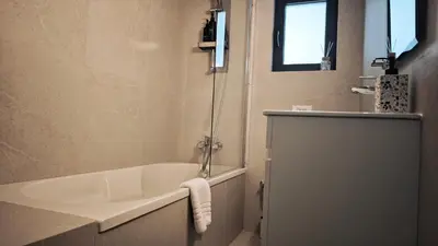 a bathroom with a bath tub and a sink at City and Sea 12 in Larnaka