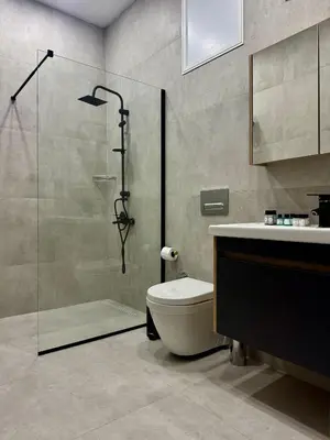 a bathroom with a shower and a toilet and a sink at Soğular Apartments 1 in Aglantzia