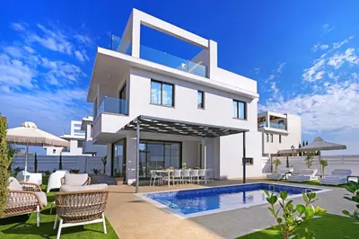 a white villa with a swimming pool and chairs at Villa Elizabeth - Pernera Resort Center in Paralimni