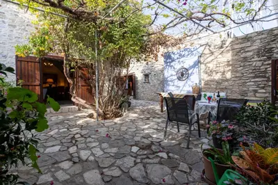 an outdoor patio with a table and chairs at Villa Monti Cozy Yard & BBQ Perfect for Families & Friends in Kato Lefkara