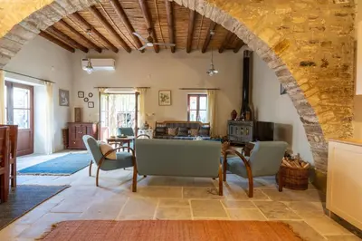 an archway in a living room with a table and chairs at Villa Monti Cozy Yard & BBQ Perfect for Families & Friends in Kato Lefkara