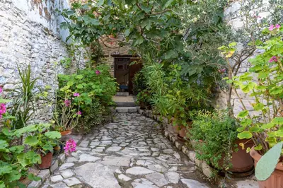 a stone path leading to a door with plants at Villa Monti Cozy Yard & BBQ Perfect for Families & Friends in Kato Lefkara