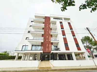 a building with a red and white facade at Alexander Residence Trikallon Str in Nicosia