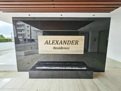 a sign for alexander residence on the side of a building at Alexander Residence Trikallon Str in Nicosia