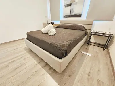 a bedroom with a bed and a wooden floor at Alexander Residence Trikallon Str in Nicosia