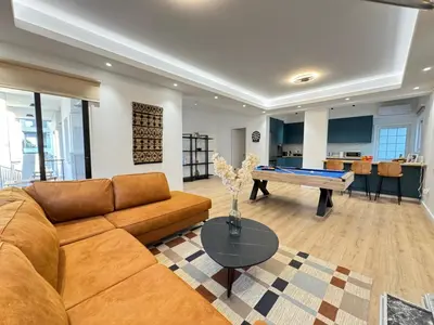 a living room with a couch and a pool table at GameHouse in the City Center in Nicosia