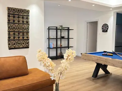 a living room with a pool table and a couch at GameHouse in the City Center in Nicosia