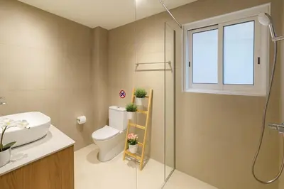 a bathroom with a toilet and a glass shower at GameHouse in the City Center in Nicosia