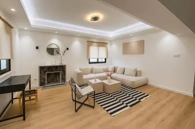 a living room with a couch and a fireplace at Cozy Boho 2-BR Retreat in Central Nicosia in Nicosia