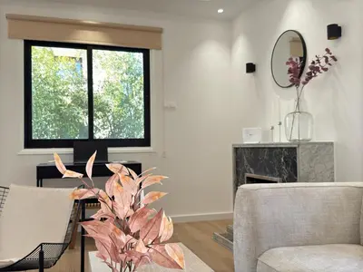 a living room with a plant and a window at Cozy Boho 2-BR Retreat in Central Nicosia in Nicosia