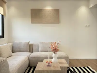 a living room with a couch and a table at Cozy Boho 2-BR Retreat in Central Nicosia in Nicosia