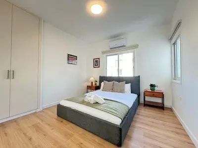 a bedroom with a bed and a window at Cozy Boho 2-BR Retreat in Central Nicosia in Nicosia