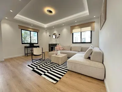 a living room with a couch and a table at Cozy Boho 2-BR Retreat in Central Nicosia in Nicosia