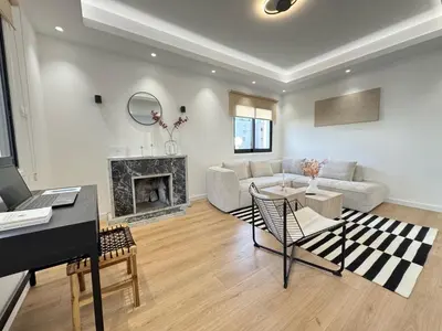 a living room with a piano and a fireplace at Cozy Boho 2-BR Retreat in Central Nicosia in Nicosia
