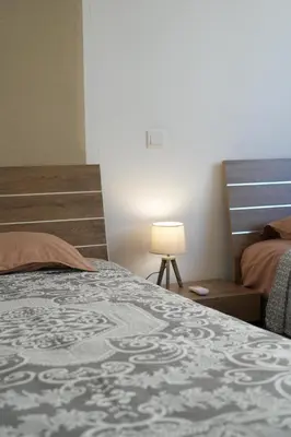 a bedroom with a bed and a lamp next to it at Larnaca Salt Lake Gem, Airy 2 BDRM Apartment in Larnaka
