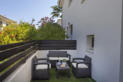 a patio with chairs and a table on a balcony at SunnyVillas 3BR House Private Pool POLY in Protaras