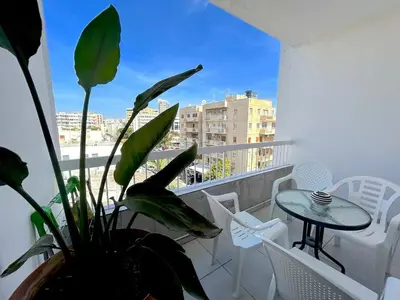 a balcony with a table and a potted plant at City Center Getaway in Nicosia