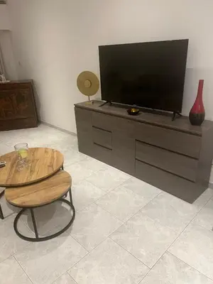 a living room with a flat screen tv on a dresser at City Center Getaway in Nicosia