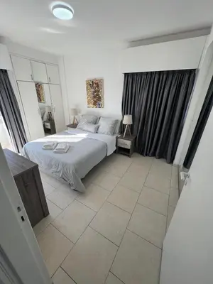 a bedroom with a bed and a tiled floor at City Center Getaway in Nicosia