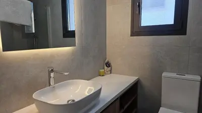 a bathroom with a sink and a toilet and a mirror at STAY Engomi Gem 2 in Engomi