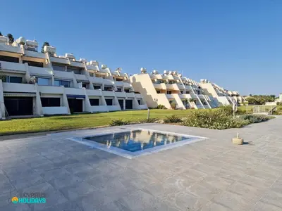 a swimming pool in front of a large building at Lordos Deluxe 2bd Duplex with pool and Seaview in Larnaka