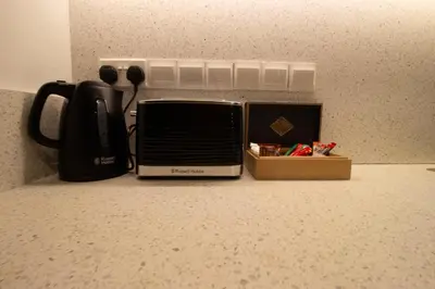 a toaster oven and a box on a counter at M-Studios - Luxury studios in the heart of Limassol in Limassol