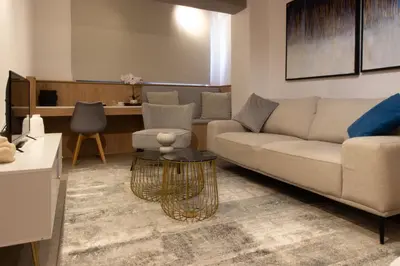 a living room with a couch and a table at M-Studios - Luxury studios in the heart of Limassol in Limassol