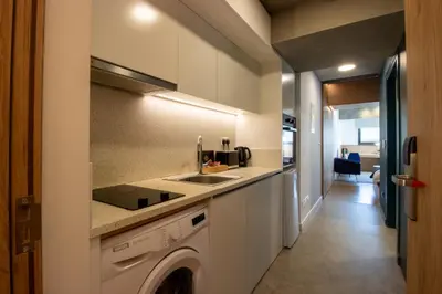 a kitchen with a sink and a washing machine at M-Studios - Luxury studios in the heart of Limassol in Limassol
