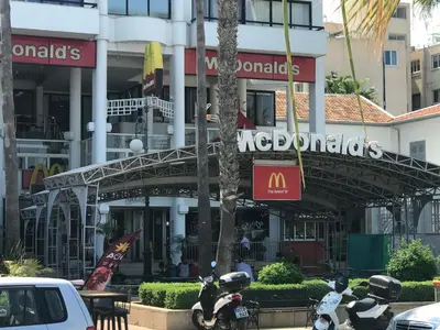 two motorcycles parked in front of a mcdonalds restaurant at Panoramic Sea View Apartments in Larnaka