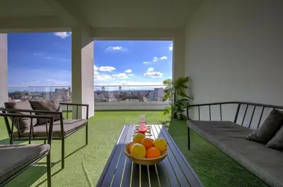 a living room with a bowl of oranges on a table at STYLE Limassol by Ezoria Villas in Limassol