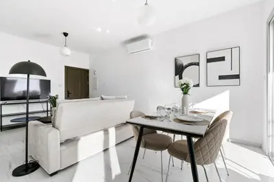 a living room with a table and a couch at STYLE Limassol by Ezoria Villas in Limassol