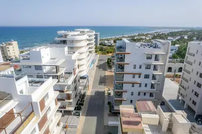 an aerial view of apartment buildings near the ocean at Mackenzie Signature Studio Suite in Larnaca in Larnaka