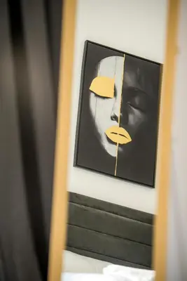 a framed picture of a woman on a wall at Mackenzie Signature Studio Suite in Larnaca in Larnaka