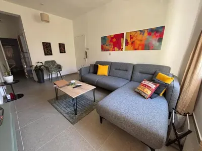a living room with a couch and a table at Flat Koskluciftlik in Nicosia