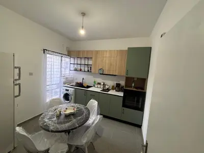 a small kitchen with a table and chairs in it at Flat Koskluciftlik in Nicosia