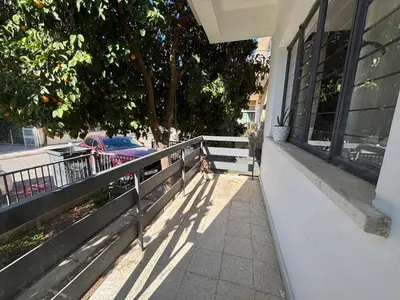 a fence on a sidewalk next to a building at Flat Koskluciftlik in Nicosia