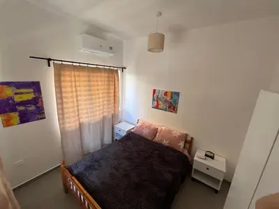 a small bedroom with a bed and a window at Flat Koskluciftlik in Nicosia