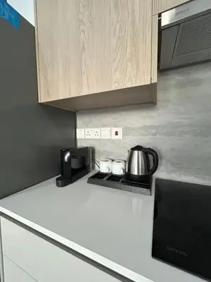 a kitchen counter with a coffee pot on a stove at AFRODITI Living in Nicosia