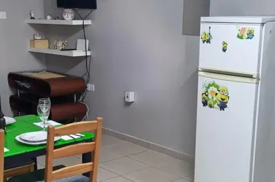 a kitchen with a table and a white refrigerator at 2br-7 Guests-Free Parking-Pool-AirCon in Paralimni
