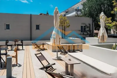 a patio with chairs and tables and umbrellas at SunnyVillas Suite Mythical GYM Swimming Pool S19 in Paralimni