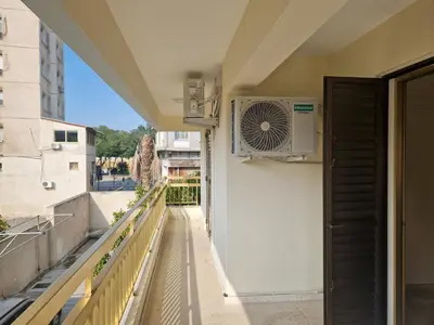 a balcony with a fan on the side of a building at Urban Nest Central Nicosia - Spacious 2BR Apartment in Nicosia