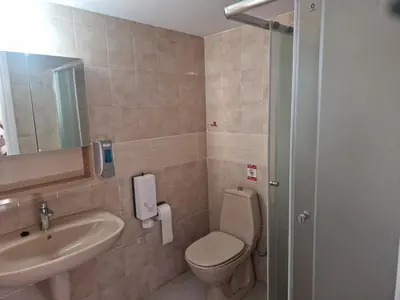 a bathroom with a toilet and a sink at Urban Nest Central Nicosia - Spacious 2BR Apartment in Nicosia