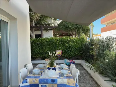 a table with a blue and white table cloth at Seaside Sunrise Familly Villa in Paralimni