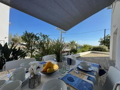 a table with a bowl of fruit on a balcony at Seaside Sunrise Familly Villa in Paralimni