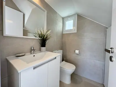a bathroom with a sink and a toilet at Seaside Sunrise Familly Villa in Paralimni