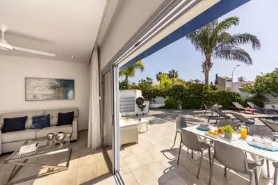 a living room with a couch and a table at Pantaros Luxury Villas with pool in Paralimni