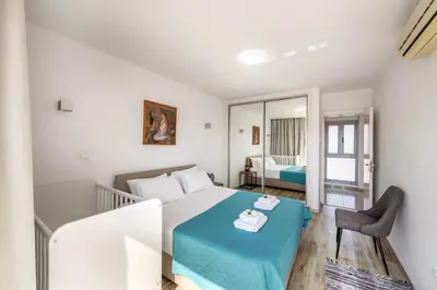 a bedroom with a bed with a blue blanket at Pantaros Luxury Villas with pool in Paralimni
