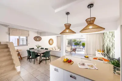 a kitchen and living room with pendant lights at Pantaros Luxury Villas with pool in Paralimni
